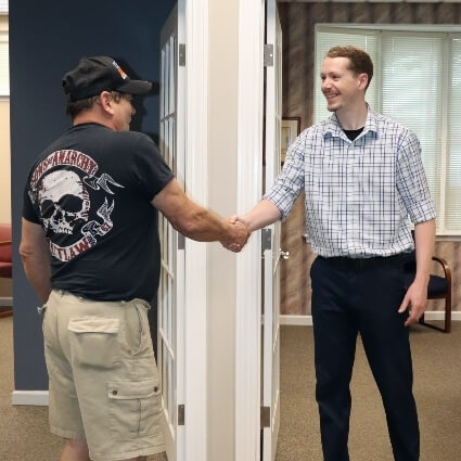 Dr Logan shaking patients hand
