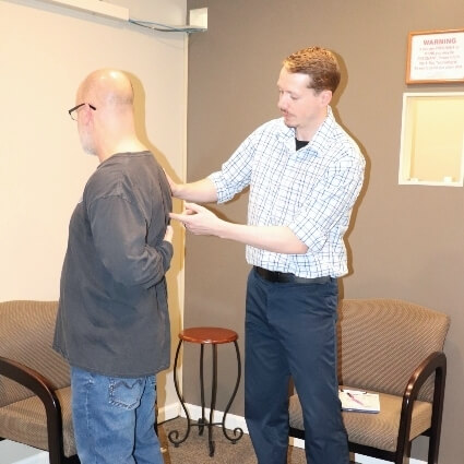Dr Logan examining patient