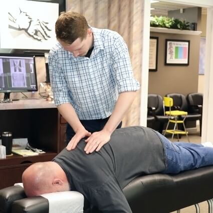 Dr Logan adjusting patients back