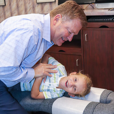 Dr. Stuckey adjusting young patient