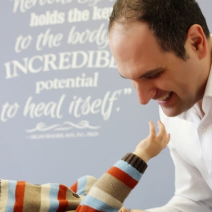 Dr Ryan adjusting baby
