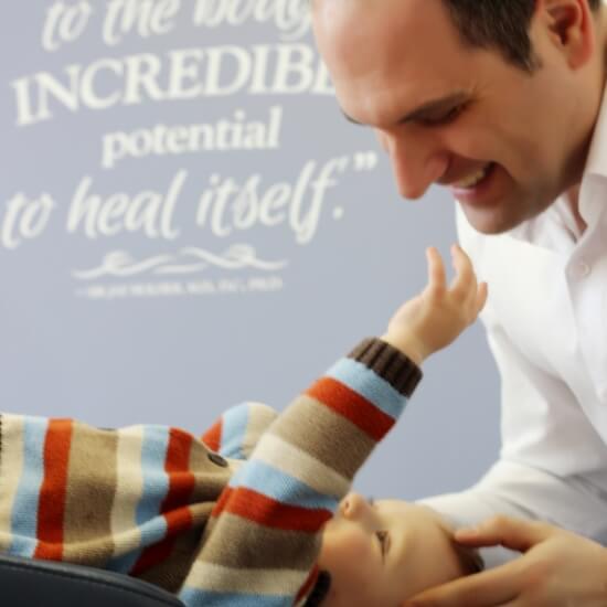 Dr. Ryan playing with baby