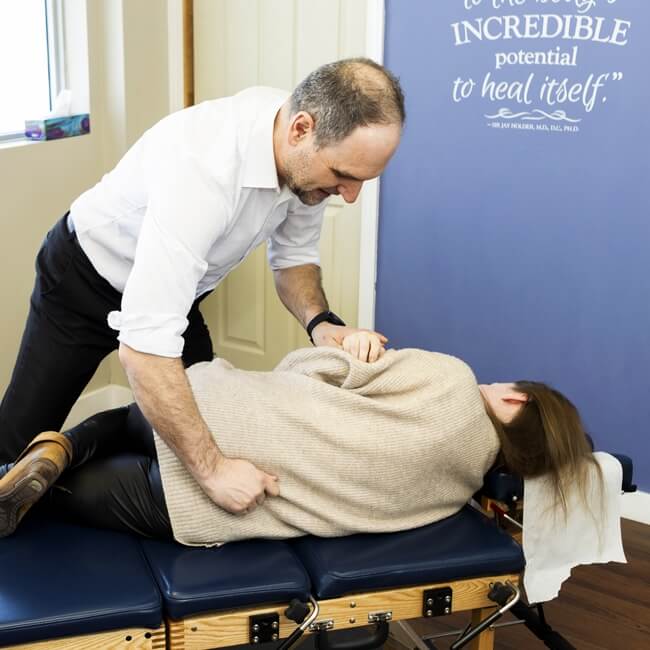 Dr. Ryan adjusting patient