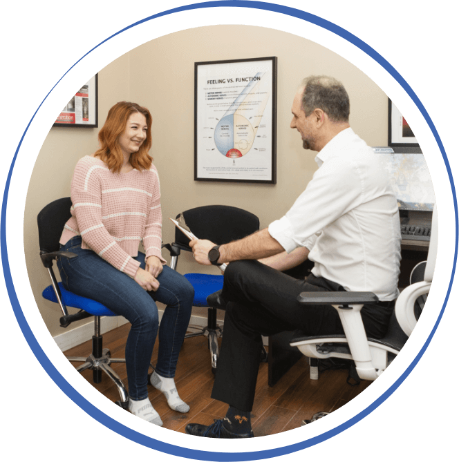 Chiropractor talking to patient