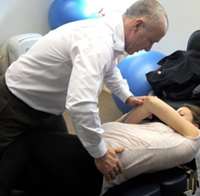 Dr Graeme Brooks (Chiropractor) treating a patient