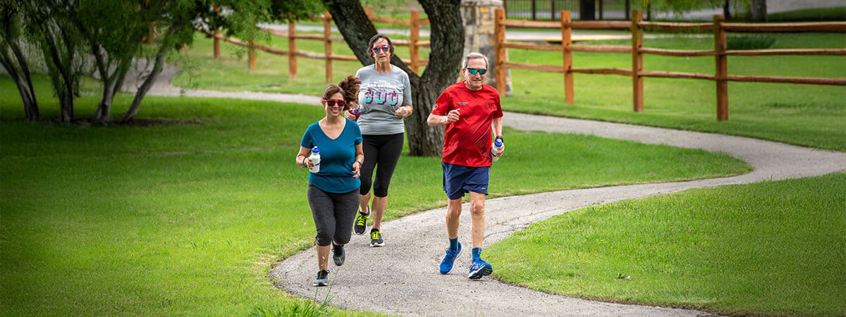 people jogging on outdoor path