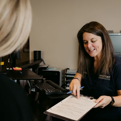 front desk pointing paperwork