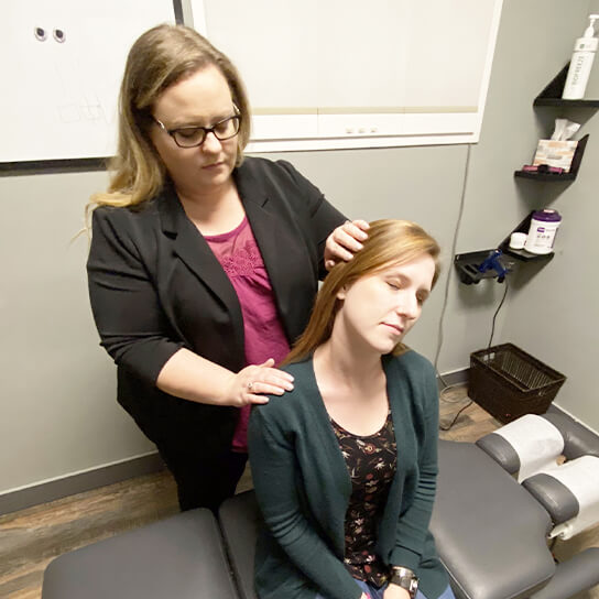 Dr. Michelle adjusting woman's neck