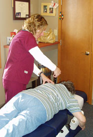 Dr. Lori adjusting patient
