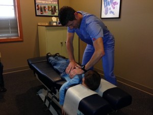 Dr. Jamie, Columbia City Chiropractor adjusting a child