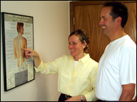 Dr. Lori with a patient explaining how we may help.