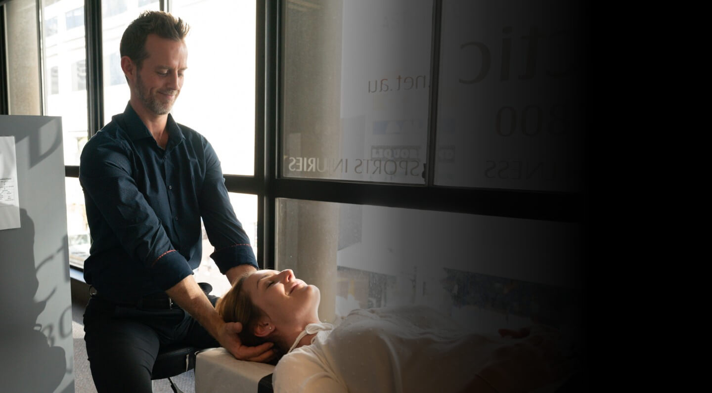 Dr Bradley adjusting persons shoulder