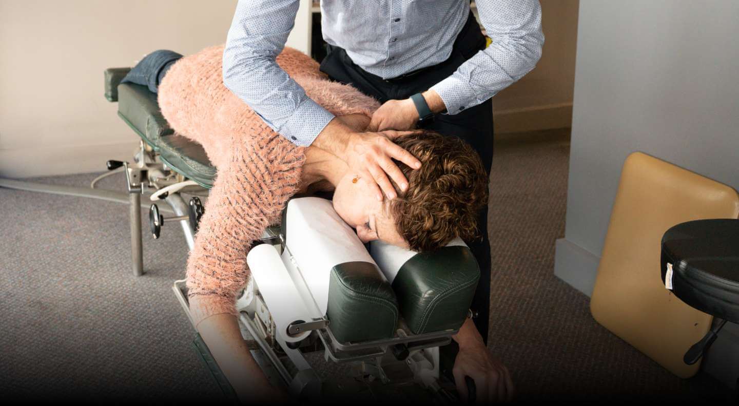 Dr Bradley adjusting persons shoulder
