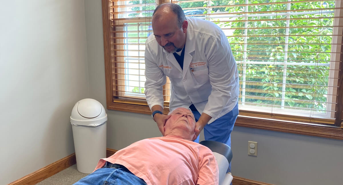 Chiropractor adjusting patient's neck
