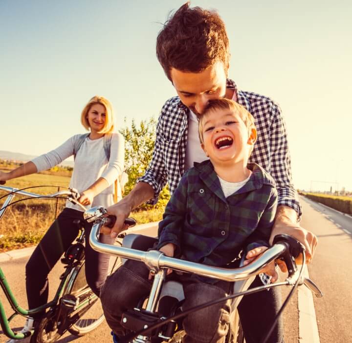 Family of three riding on bicycles