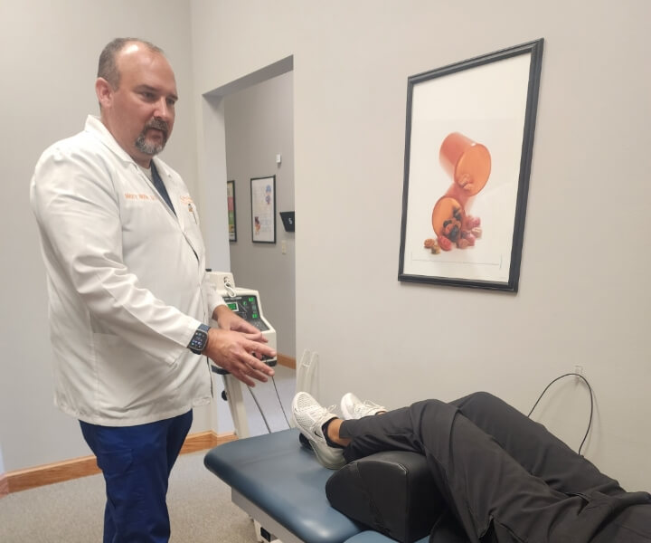 Wooster chiropractor Dr. Marty Moore talking to a patient
