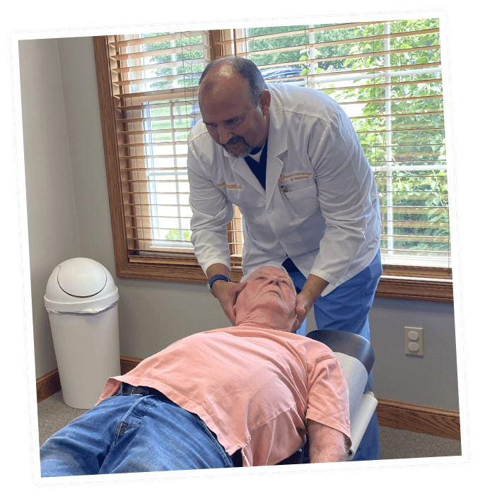 Gentle neck adjustment for male patient at Moore Chiropractic & Wellness