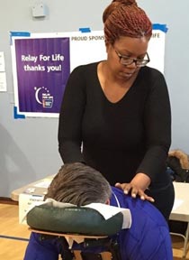 Adele Green LMT in Brooklyn providing chair massage at a neighborhood Zumba event. 