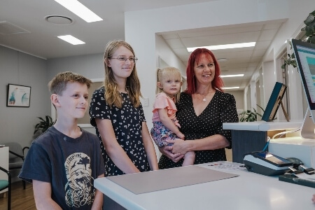 Group of patients standing at reception