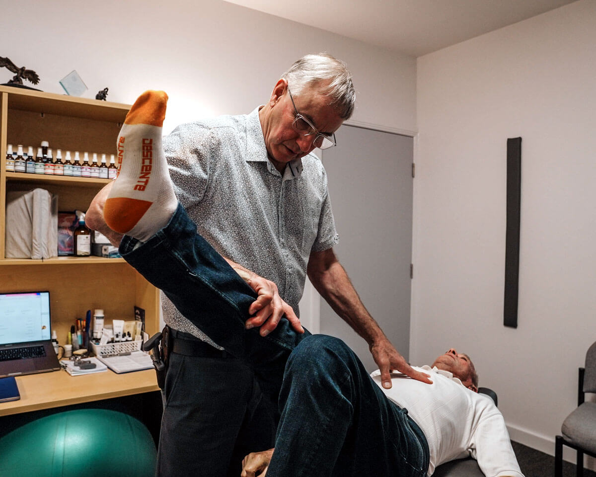 Chiropractor discussing supplements with two Toowoomba patients