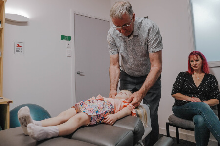 Paediatric patient receiving a chiropractic adjustment