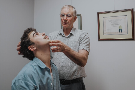 Toowoomba chiropractor adjusting patient's neck