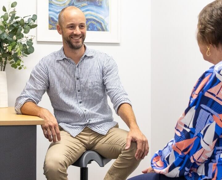 Chiropractor talking to patient