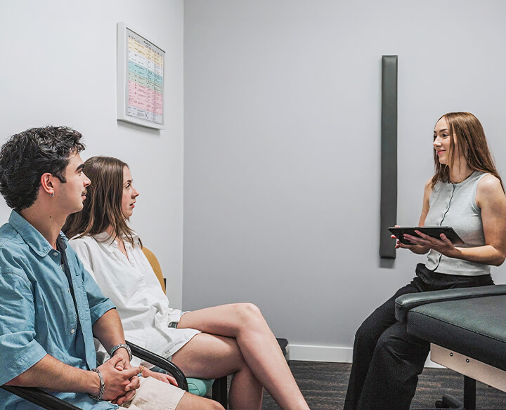 Chiropractor talking to patient