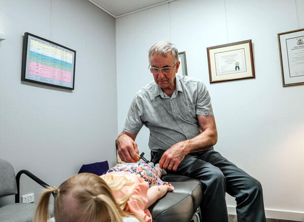 Toowoomba chiropractor stretching female patient's arm
