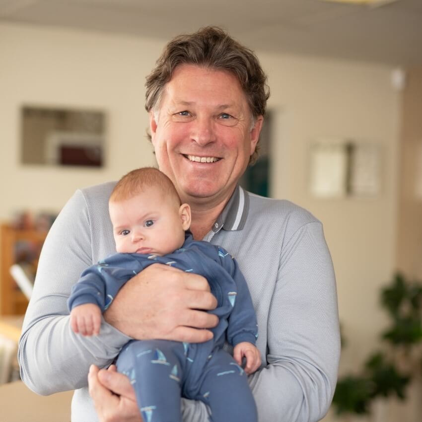 Dr Brett adjusting baby laying on neck
