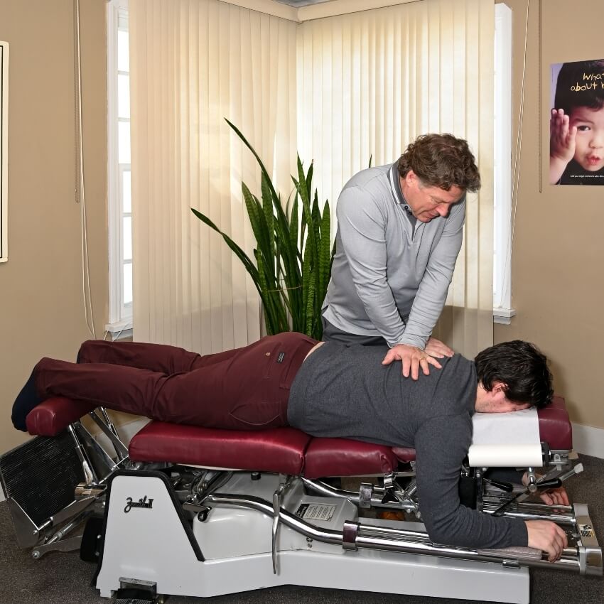 Dr Brett adjusting patients back