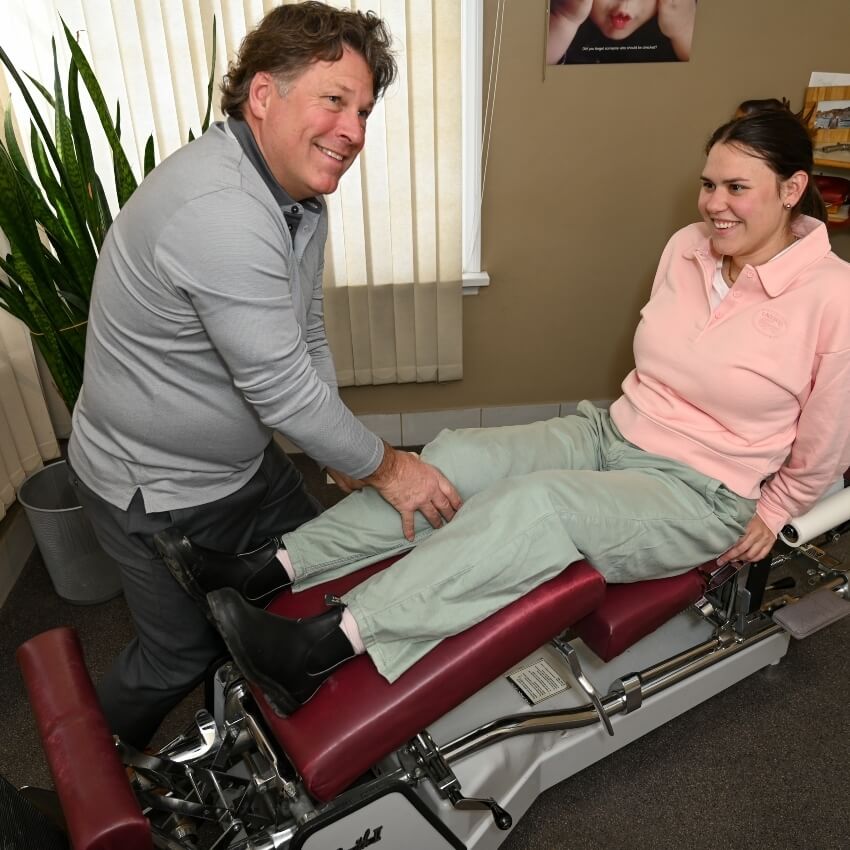 Dr Brett adjusting patients knee