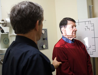 Dr. Dan Fonke performing an X-ray on a patient. Dr. Dan Fonke performing an X-ray on a patient.