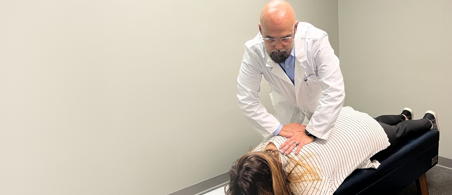 Hamilton chiropractor Dr Thad adjusting patients back