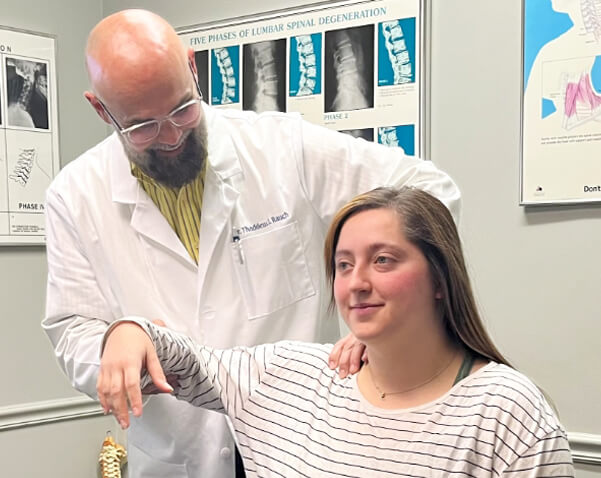 Hamilton chiropractor Dr Thad adjusting patients shoulder