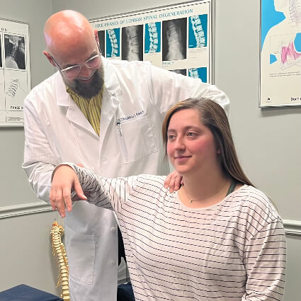 Dr Thad helping patient to stretch