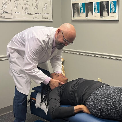 Chiropractic adjustment on patients neck