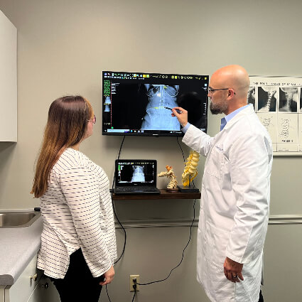 Dr Thad showing xrays to patient