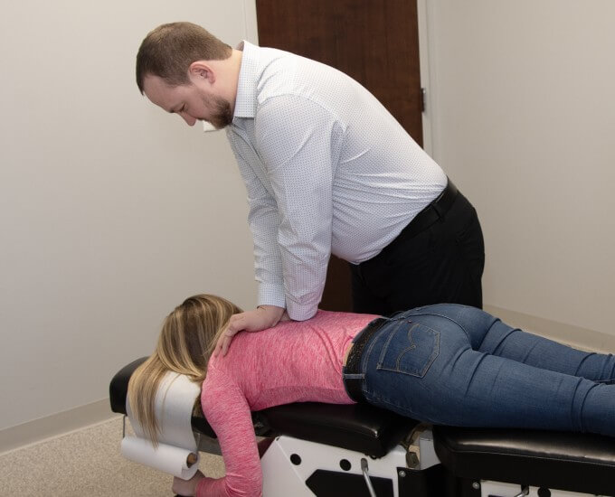 Dr. Adam adjusting patient