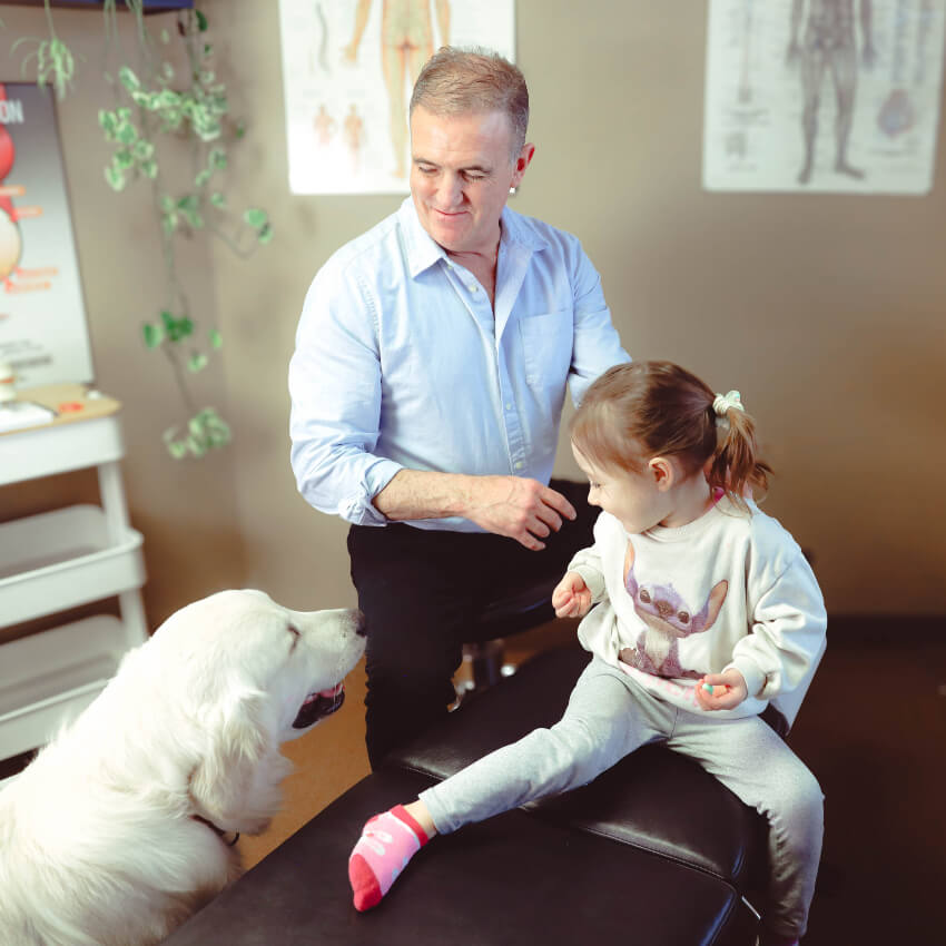 Dr Gillis with a patient and office dog