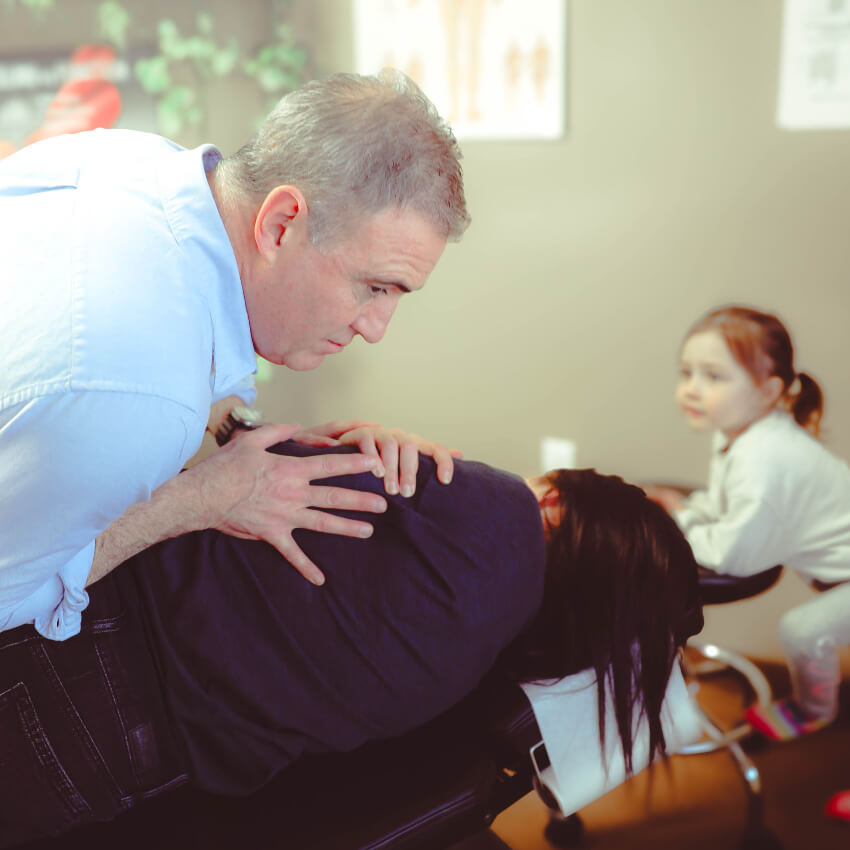 Dr Gillis adjusting patients back