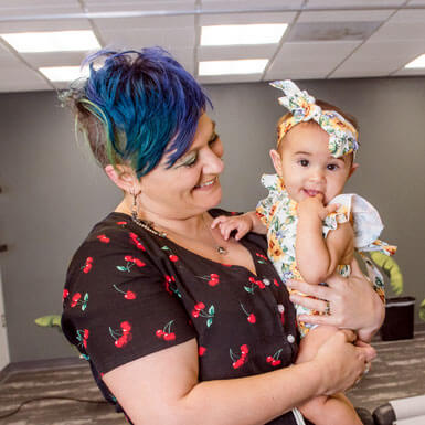 Dr. Lisa holding a baby