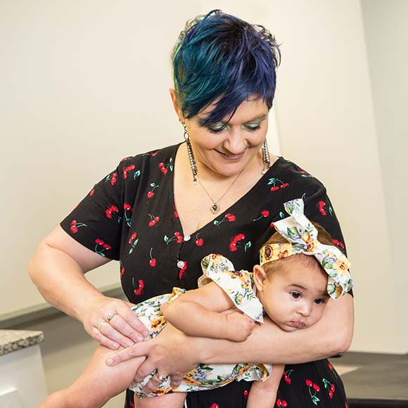 Chiropractor holding baby