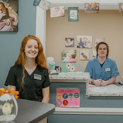 front desk team smiling