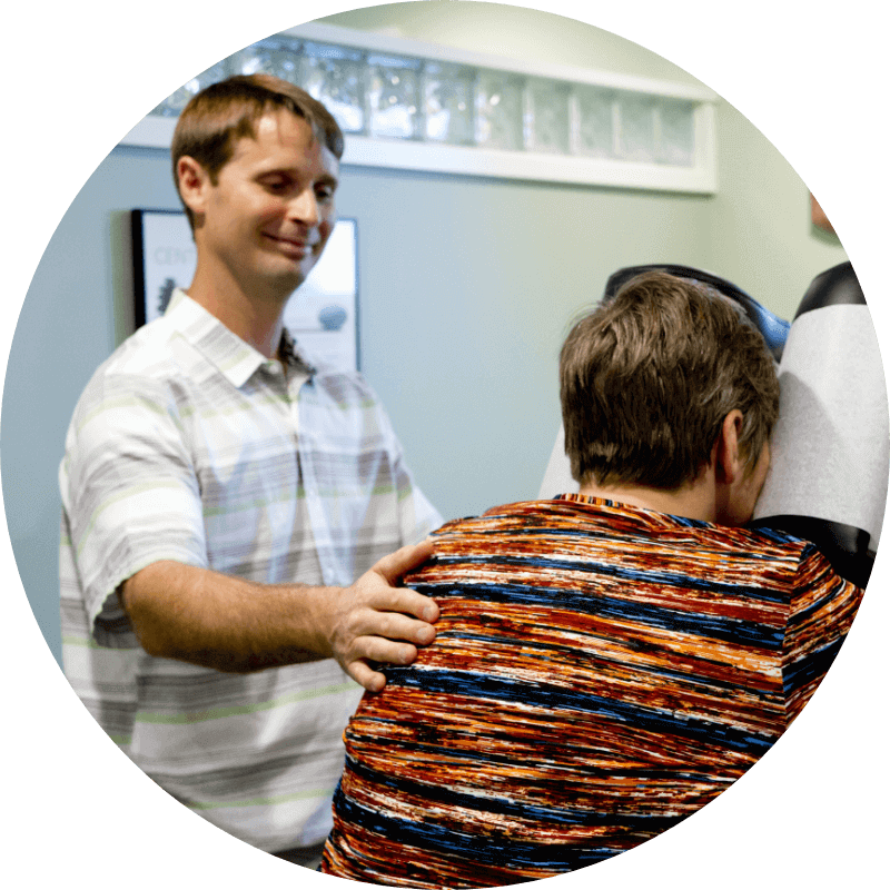 Bellingham Chiropractor Dr. Andrew Winn with patient on adjusting table