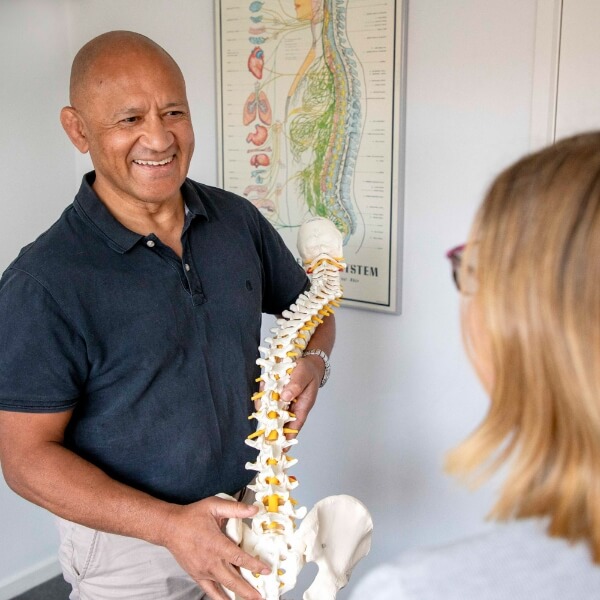 Keysborough chiropractor holding a model of a spine