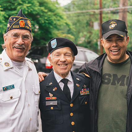 3 veterans smiling together