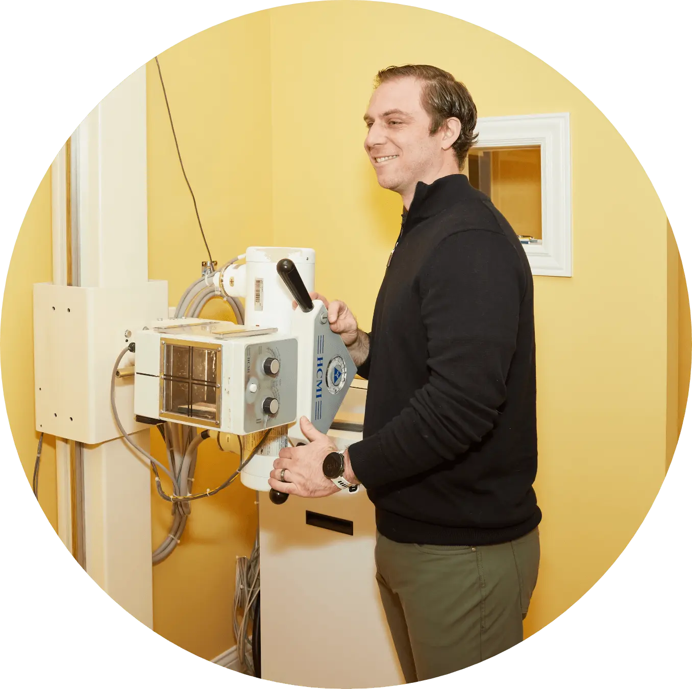 Chiropractor operating x-ray machine