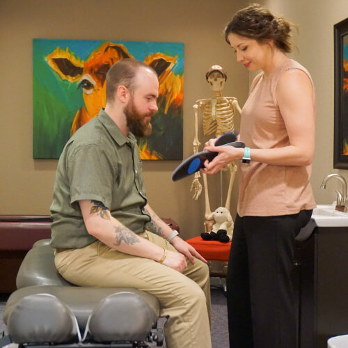 Rapid City patient discussing orthotics with chiro