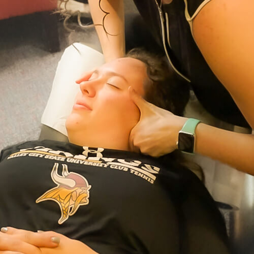 Female patient getting her neck adjusted
